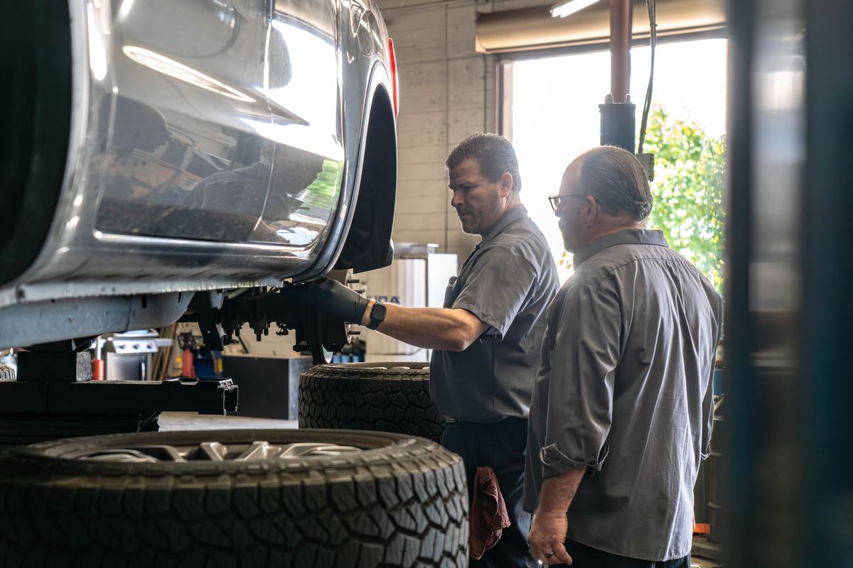 Two technicians inspecting a truck wheel at our West Sacramento shop